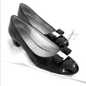 Black chunk heel Ferragamo’s with a gold bow